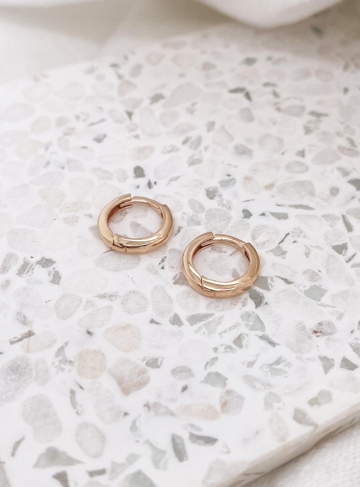 Aurelia Teeny Tiny Huggie Hoop Earrings in 9ct Rose Gold